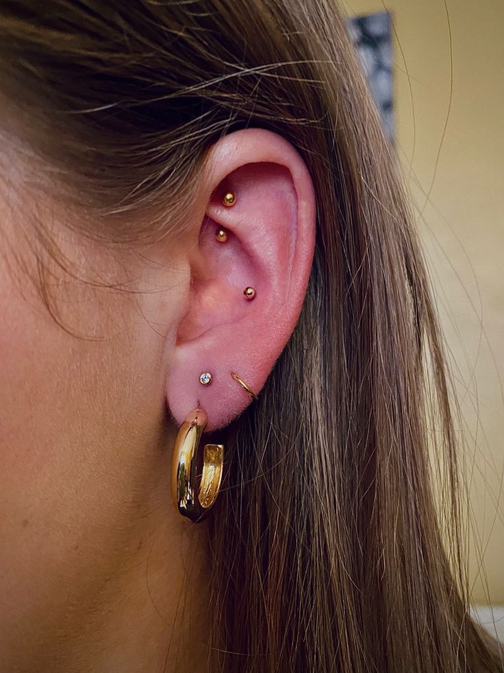 a close up of a person wearing some kind of earring with one piece of jewelry on it