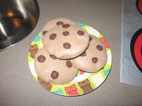 three cookies on a plate next to a bowl