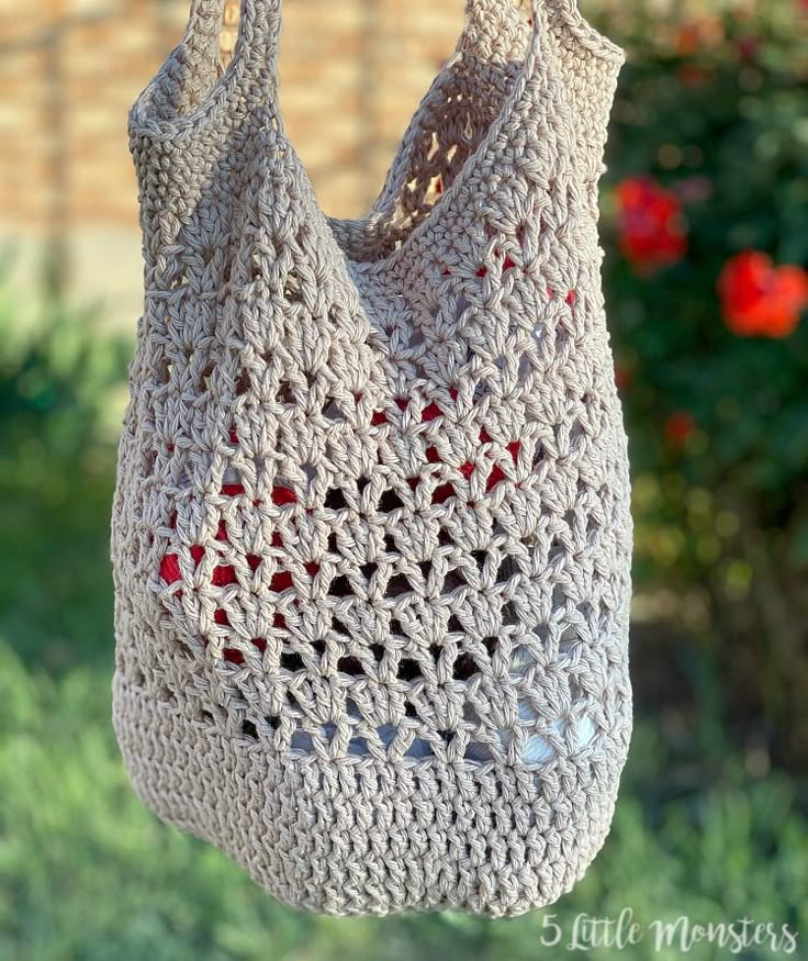 a crocheted bag hanging from a clothes line