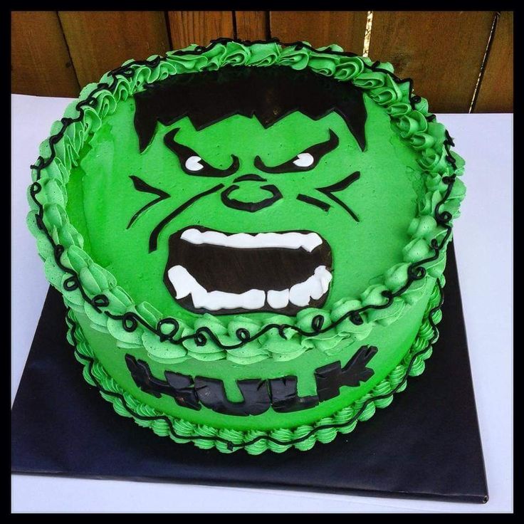 there is a green cake that looks like the incredible hulk from the movie avengers on it