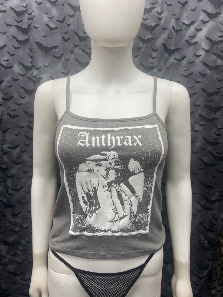 This is a gray Anthrax crop tank top with spaghetti straps. This has a Anthrax image screen printed on the front. 57% cotton/ 38% polyester/ 5% Spandex These are handmade screenprinted and slightly vary from the photo. Please feel free to email me any questions. Thanks for looking. Due to an influx of incorrect addresses if a package is returned, you must pay the shipping cost to resend the item to you. The seller is not responsible for any lost or stolen packages. Gothic Summer Camisole Top, Gothic Style Camisole Tops For Summer, Summer Gothic Camisole Tops, Alternative Cotton Crop Top For Concert, Gray Cotton Punk Style Top, Punk Cotton Crop Top For Concerts, Punk Style Cotton Crop Top For Concerts, Alternative Style Summer Graphic Print Crop Top, Alternative Style Summer Crop Top With Graphic Print