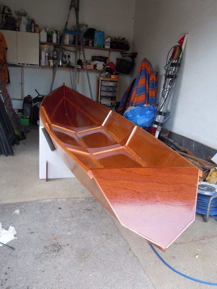 a wooden boat is sitting in a garage