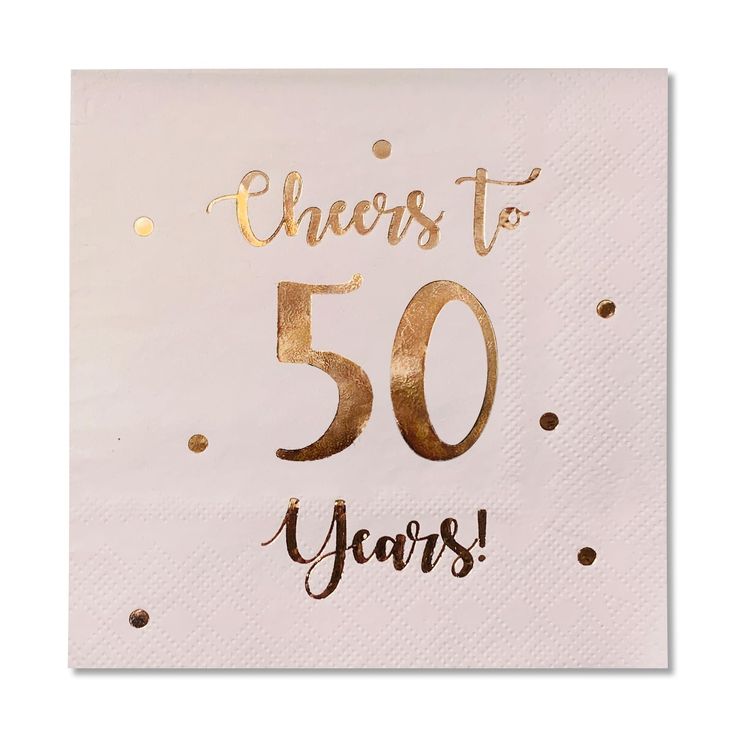 a white napkin with gold foil lettering that says cheers to 50 years