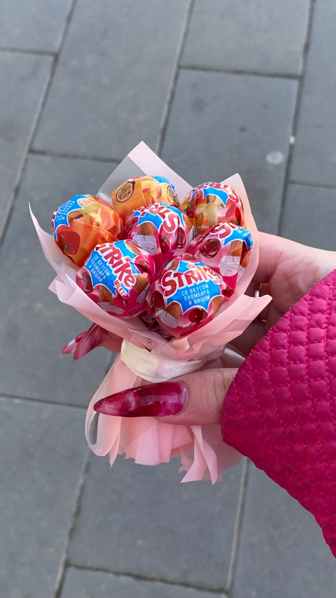 a person holding a bunch of candy in their hand