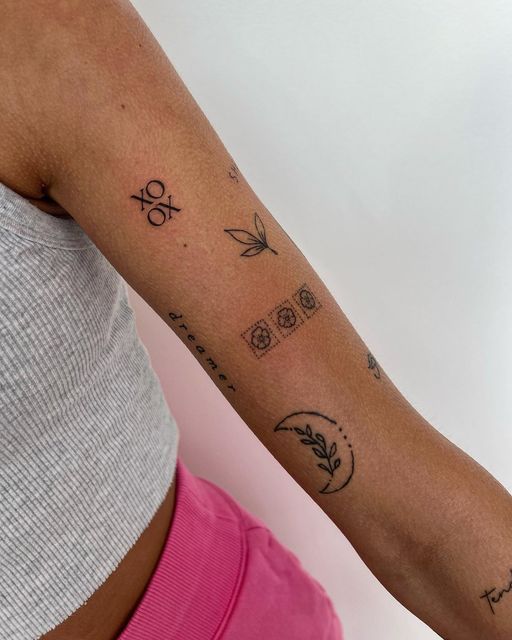 a woman's arm with tattoos on it