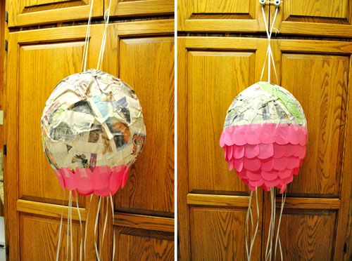 two balloons are hanging on the wall in front of a cupboard with papers taped to them