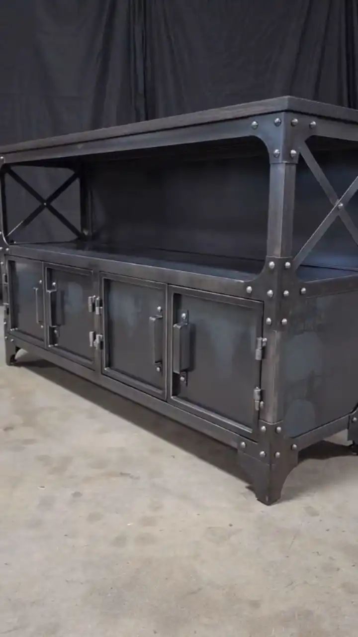 a large metal storage unit sitting on top of a cement floor next to a black wall