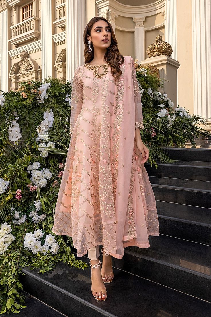 Peach Salwar Kameez with Delicate Embroidery is a Beautiful Pakistani Formal Dress with eye-catching yet soothing decorations on it depicting a perfectly magical picture. Fine embroidered patterns and trendy embellishments are rendering these Pakistani Clothes your ultimate choice. Frock This Pakistani Dress comes with a beautifully made Long frock with a beautiful flare. The fabric of this frock is fine chiffon and is emblazoned with fine embroidery work accompanied by iridescent sequins and ti Fancy Salwar Kameez, Peach Pakistani Outfit, Peach Festival Outfit, Peach Salwar Kameez, Flared Salwar Suit, Chiffon Fancy Dress Pakistani, Frock Salwar Suit Design Pakistani, Indian Fashion Dresses Salwar Kameez, Pakistani Engagement Dresses Simple Salwar Kameez