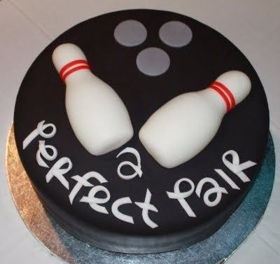 there is a cake that has two bowling pins on it