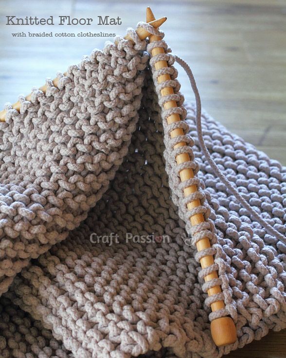 a close up of a knitted floor mat on a wooden surface with text overlay that says, knitted floor mat