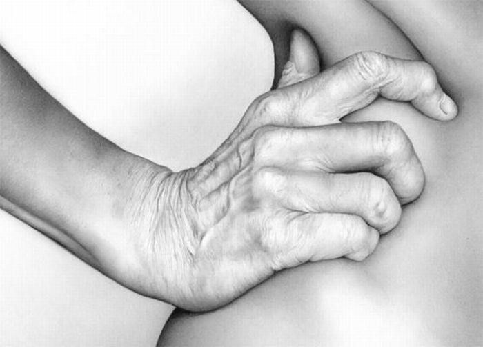 an old woman holding her hand on the back of her stomach in black and white