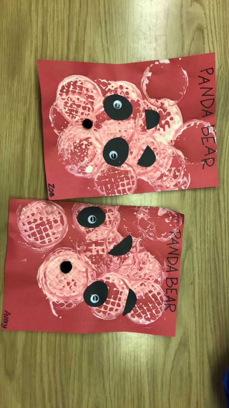 two pieces of red paper with black and white images on them, one is made to look like a teddy bear