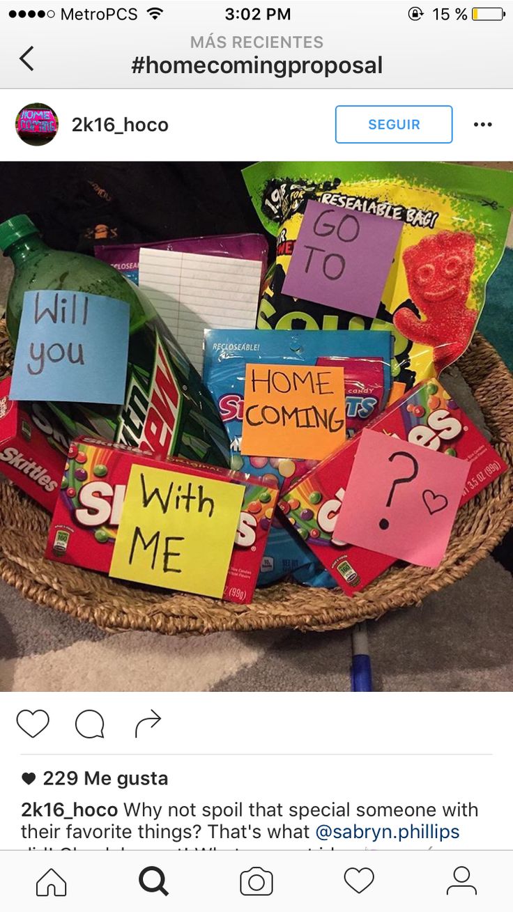 a basket filled with lots of candy on top of a table next to a pile of cards