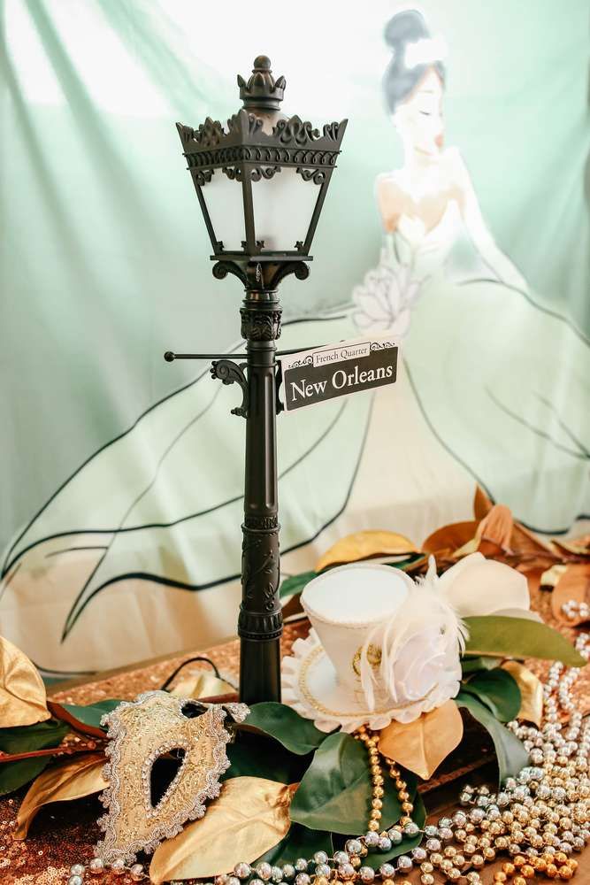 a lamp post with flowers and pearls around it