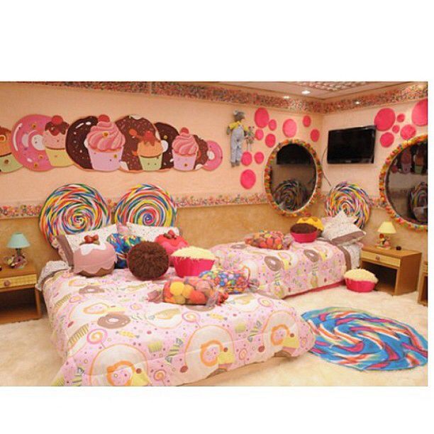 a bedroom decorated in pink and white with lots of decorations on the walls, two twin beds