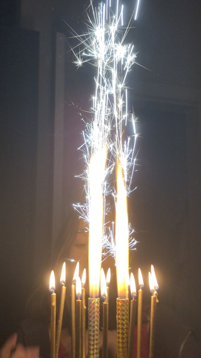 a birthday cake with lit candles on it