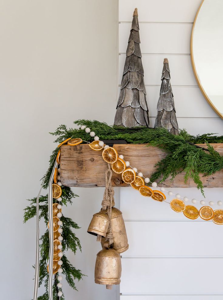 a christmas mantle with ornaments and bells on it