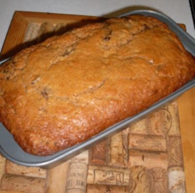 a loaf of bread sitting on top of a wooden cutting board