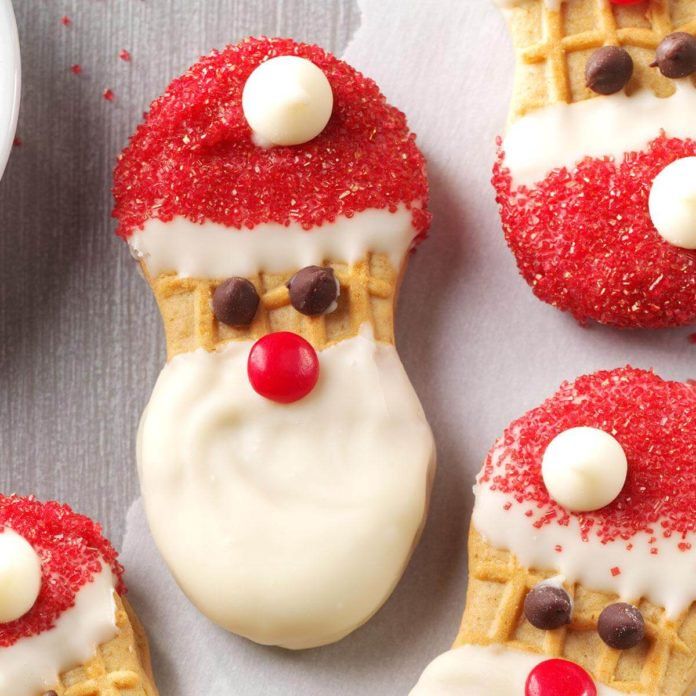 christmas themed waffles with white frosting and red candies on them, decorated like santa claus