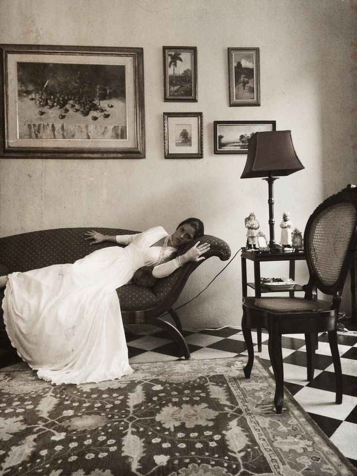 a woman laying on top of a couch in a living room