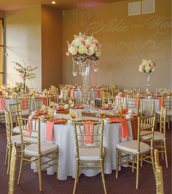 the tables are set up with white and pink linens for an elegant wedding reception