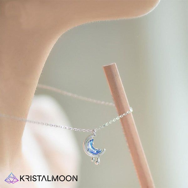 Just like the moon shifting every single night, so does the adaptation of our soul until we reach a peak of fullness that allows us to reflect and start a new chapter in our lives. This beautifully constructed, rich blue moon necklace reminds us that though we may go through hardships, we soon enough in time will reach “fullness” and learn, understand and grow from past mistakes and traumas. The water droplets symbolizes constant movement, so is the natural growth of our souls, just like a sprin Mystical Blue Pendant Necklace, Magical Blue Pendant Jewelry, Magical Moon-shaped Sterling Silver Necklace, Magical Moon Shaped Sterling Silver Necklace, Blue Mystical Pendant Jewelry, Mystical Blue Pendant Jewelry, Celestial Sterling Silver Crystal Necklace With Moon Charm, Elegant Blue Moon Phase Necklace, Blue Moon Phase Round Pendant Jewelry