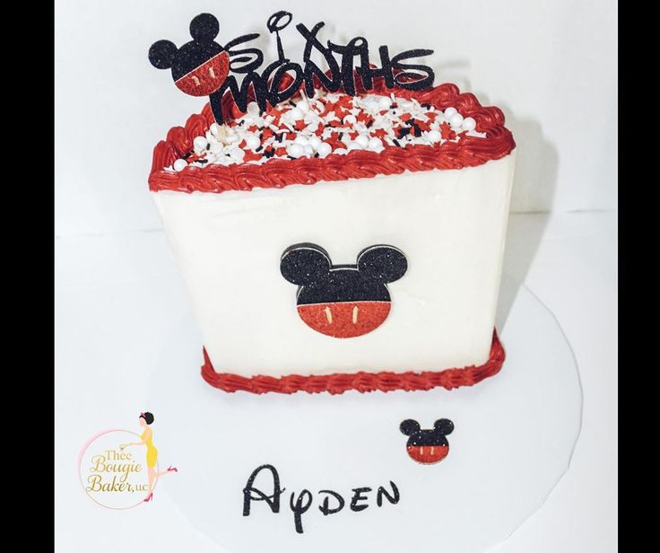 a mickey mouse birthday cake with red and white frosting