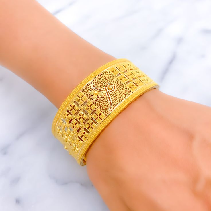 This exquisite 22k gold bangle, weighing 39.9 grams, features a bold and opulent square design that exudes elegance and sophistication. The yellow gold finish enhances its luxurious appeal, making it perfect for any special occasion. The bangle has a size of 2.8 and an opening diameter of 2.5 inches, offering both style and comfort. This piece is openable, designed with a screw and hinge for added convenience. Ideal for those who appreciate high-quality craftsmanship and timeless beauty, this bo Formal 22k Gold Cuff Bracelet, 22k Gold Cuff Bracelet For Formal Occasions, Gold Rectangular Bangle Gift, Gold 22k Formal Cuff Bracelet, Elegant Yellow Gold Plated Bangle, Gold Rectangular Cuff Bracelet Gift, Traditional 14k Yellow Gold Bangle, Elegant 22k Yellow Gold Bangle, Elegant Yellow Gold 22k Bangle