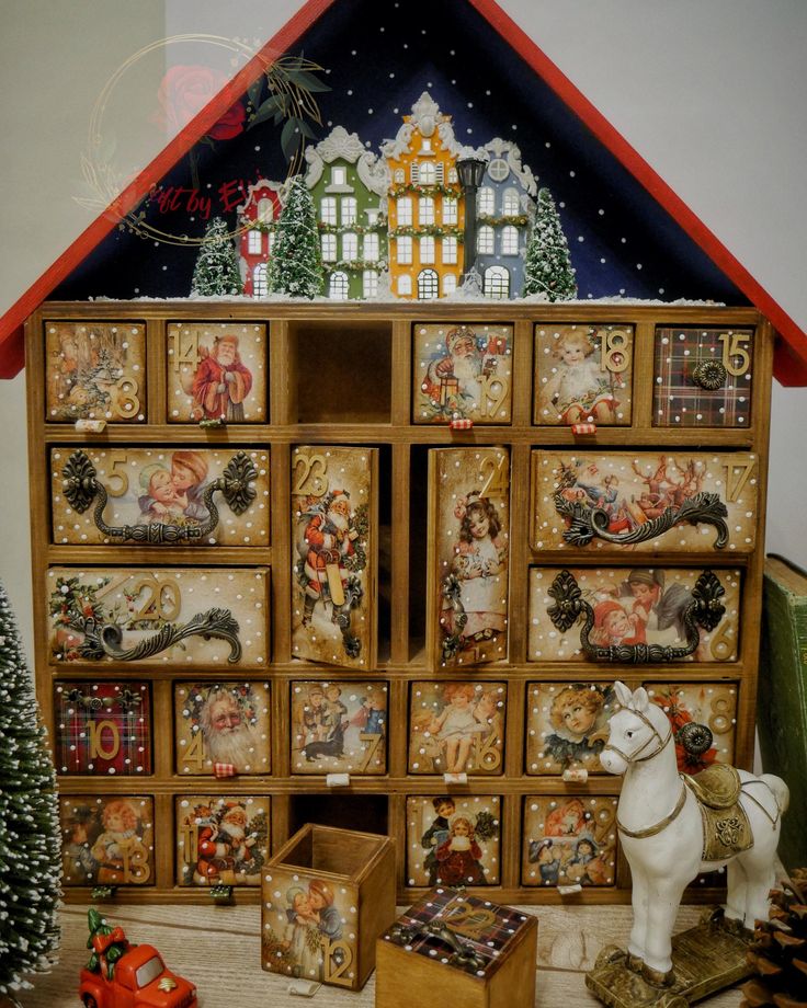 a christmas scene with a doll house and toy horse in front of the display case