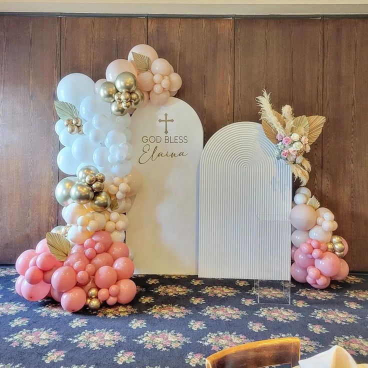 balloons and flowers decorate the front of a church's alter, with a cross in the background