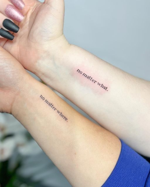 two women with matching tattoos on their arms holding each other's hands and the words together