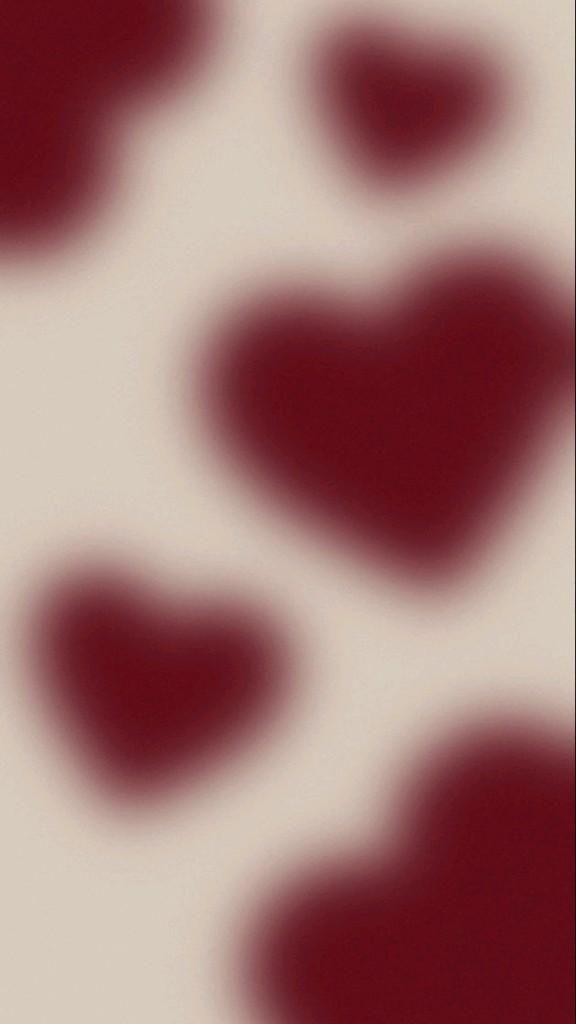 a blurry image of red hearts on a white background