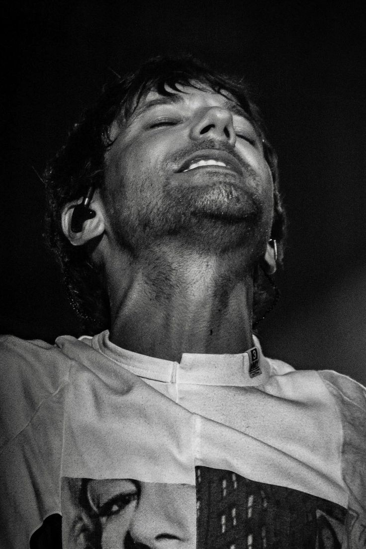 black and white photograph of a man with his eyes closed looking up at the sky