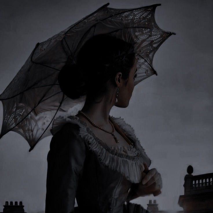 a woman holding an umbrella in the dark