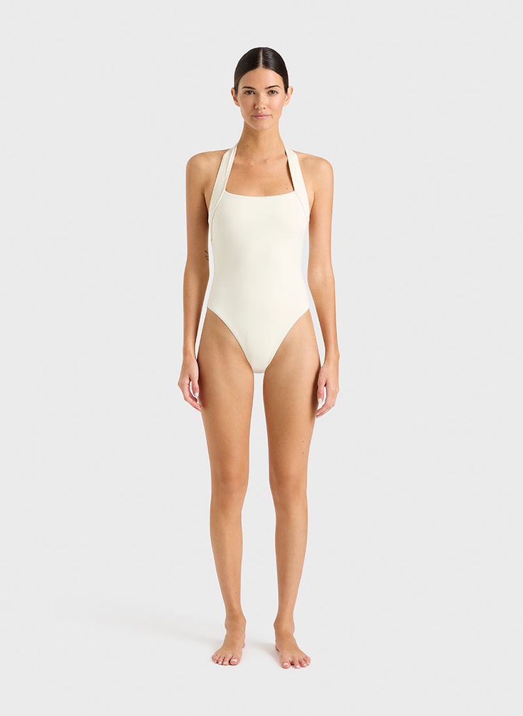 Sizes XS, L, XL, XXL on pre order - estimated dispatch date June 20th The Candice halterneck in Porcelain is an elegant and feminine one piece swimsuit that will never go out of style. The suit also works perfectly as a bodysuit worn under trousers or a skirt. A comfortable, wide, elasticated strap runs from under the shoulders and behind the neck. A scoop back reveals the shoulders. Self-lined in our ultra-soft Embodee™ fabric with high shaping power. Luxury fabric sustainably made in Italy. Australian Swimwear, Resort Wear Dresses, Halter Neck Swimsuit, Perfect Swimsuit, Luxury Fabric, Australian Fashion, Swimwear Collection, Shop Swimwear, Luxury Fabrics