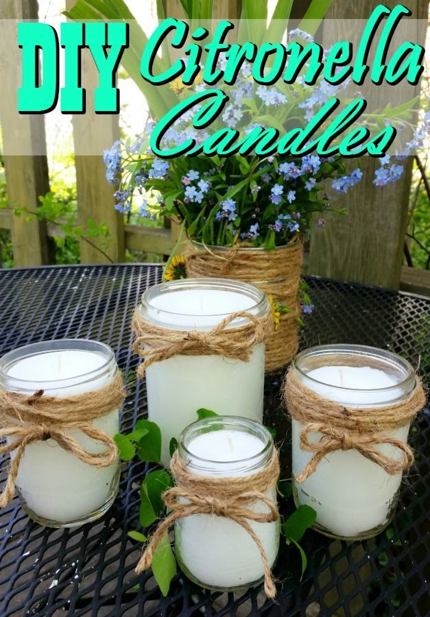 diy citronella candle with twine tied around the jars and flowers in them