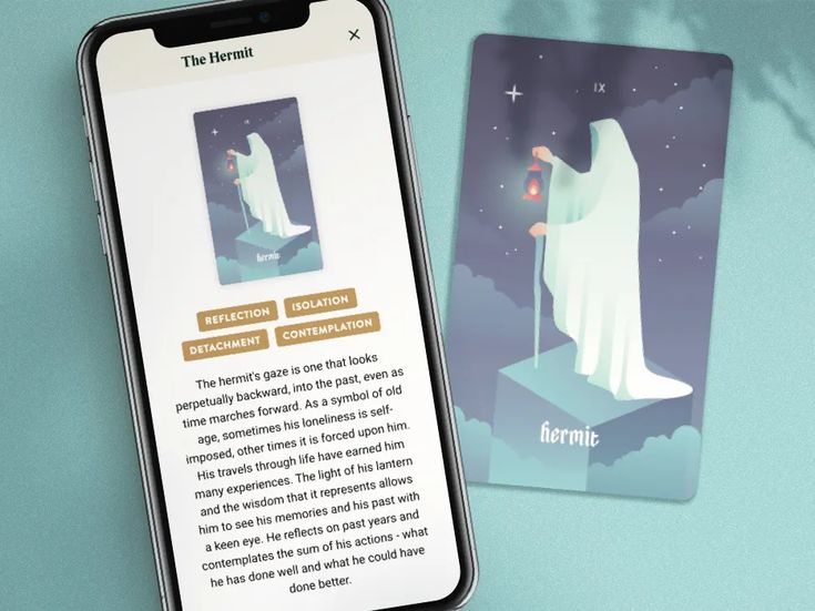 a cell phone next to a card with an image of a ghost on the screen