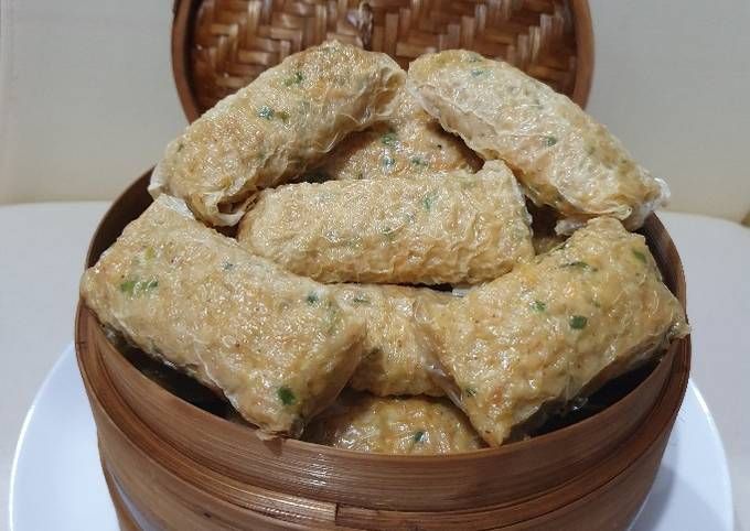 a wooden container filled with food on top of a table