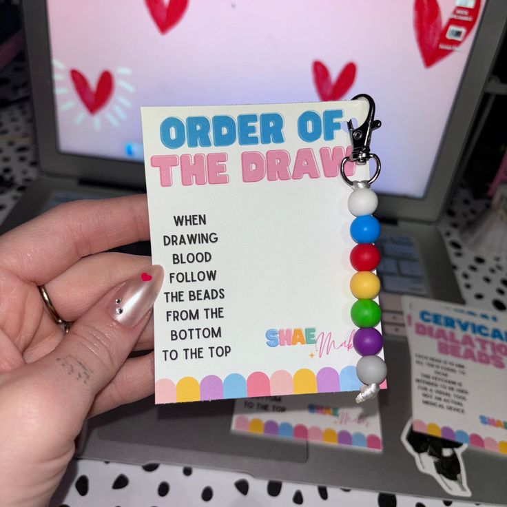 a person holding up a small card with the words order of the draw on it