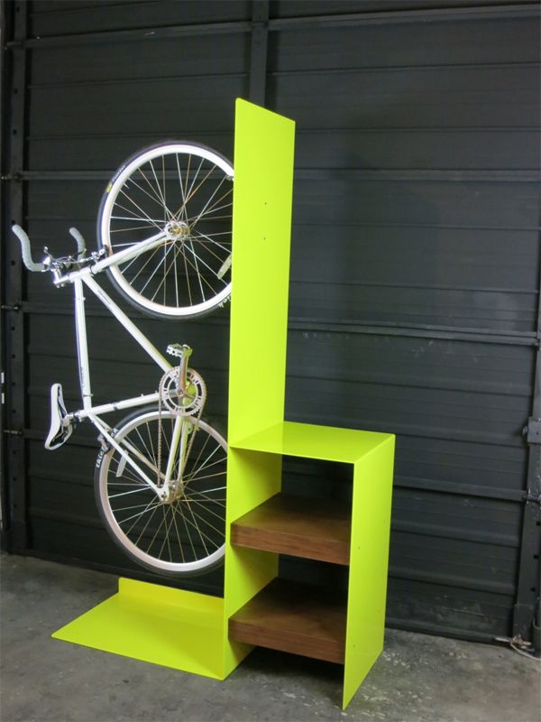 a bike mounted to the side of a green shelf