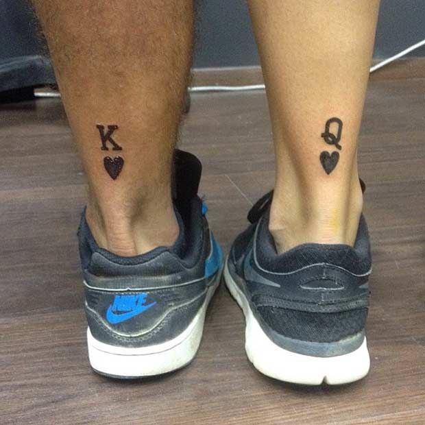 a man's legs with two small hearts tattooed on the lower part of his leg