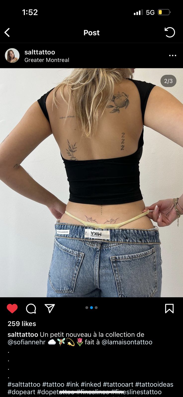 the back of a woman's stomach with tattoos on it