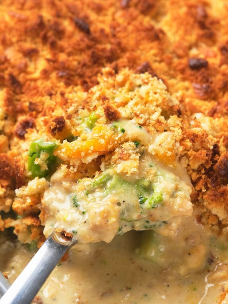 a casserole dish with broccoli, cheese and bread crumbs