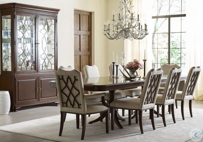 a dining room table with chairs and a chandelier