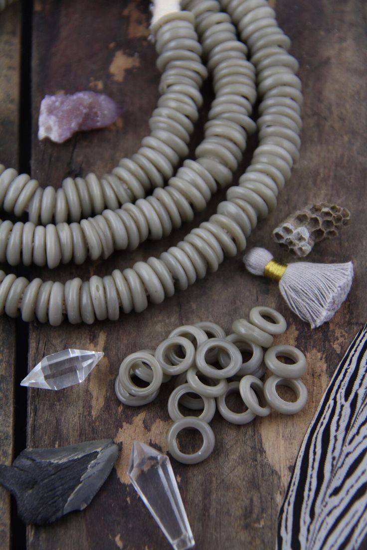 "Grey Dutch Donut Dogon Beads, Mali, Africa, Large Hole Glass Beads, Neutral Fall Boho Bohemian Tribal 11-12mm, Jewelry Making Supply, 10 pcs These are really enchanting and delicate beads hailing from the dogon Tribe in Mali. Called \"Dutch Donuts\" because of their donut-like shape, and because they formed in a style of Dutch beads that were traded into Africa. They are made of glass that was wrapped around a mandrel and formed into this round shape. These beads are wound glass, so on some bea Dogon Tribe, Mali Africa, African Trade Beads, Boho Fall, Bone Beads, Shopping World, African Beads, Trade Beads, Beignets