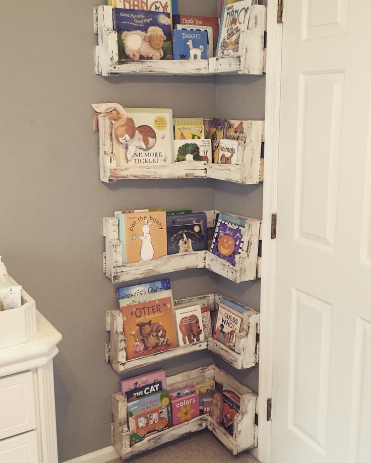 the bookshelf is made out of pallets and used as a book shelf