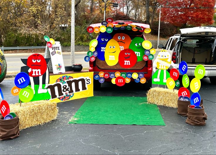 a decorated truck is parked in a parking lot with hay bales on the ground