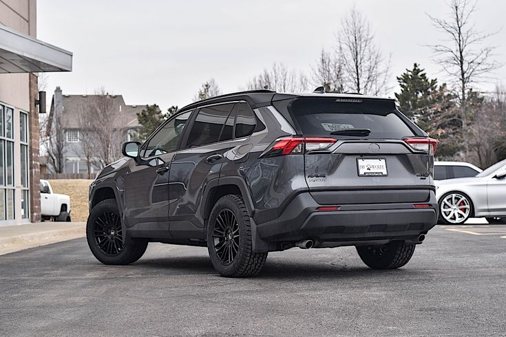 the rear end of a gray toyota rav parked in a parking lot