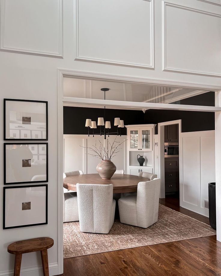 a dining room with white chairs and a table