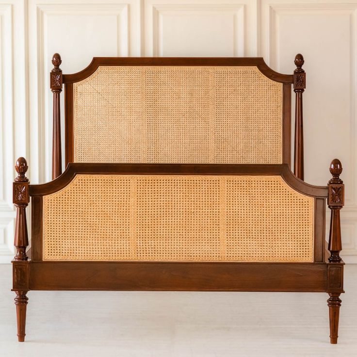 the headboard and foot board of a bed with wicker on it's sides